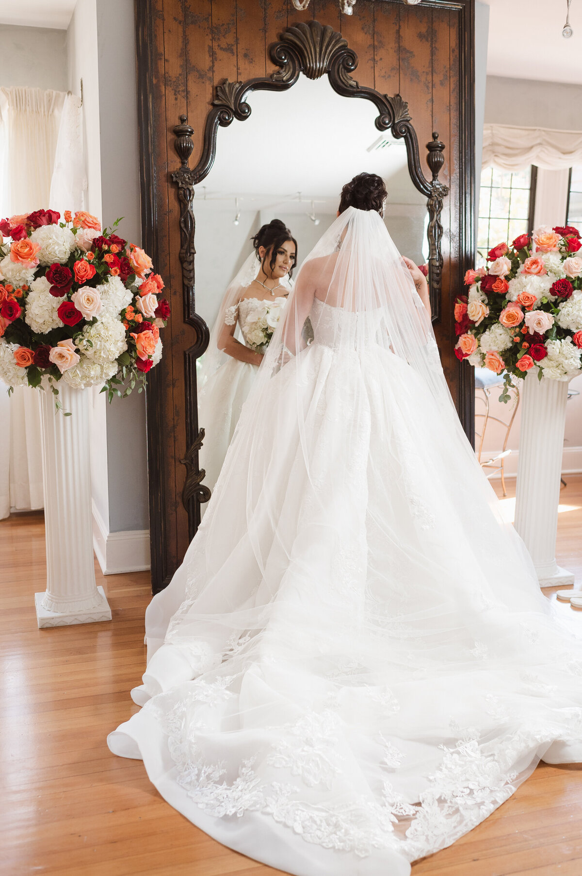 Bride looking in antique mirror at the pleasantdale chateau bridal suite