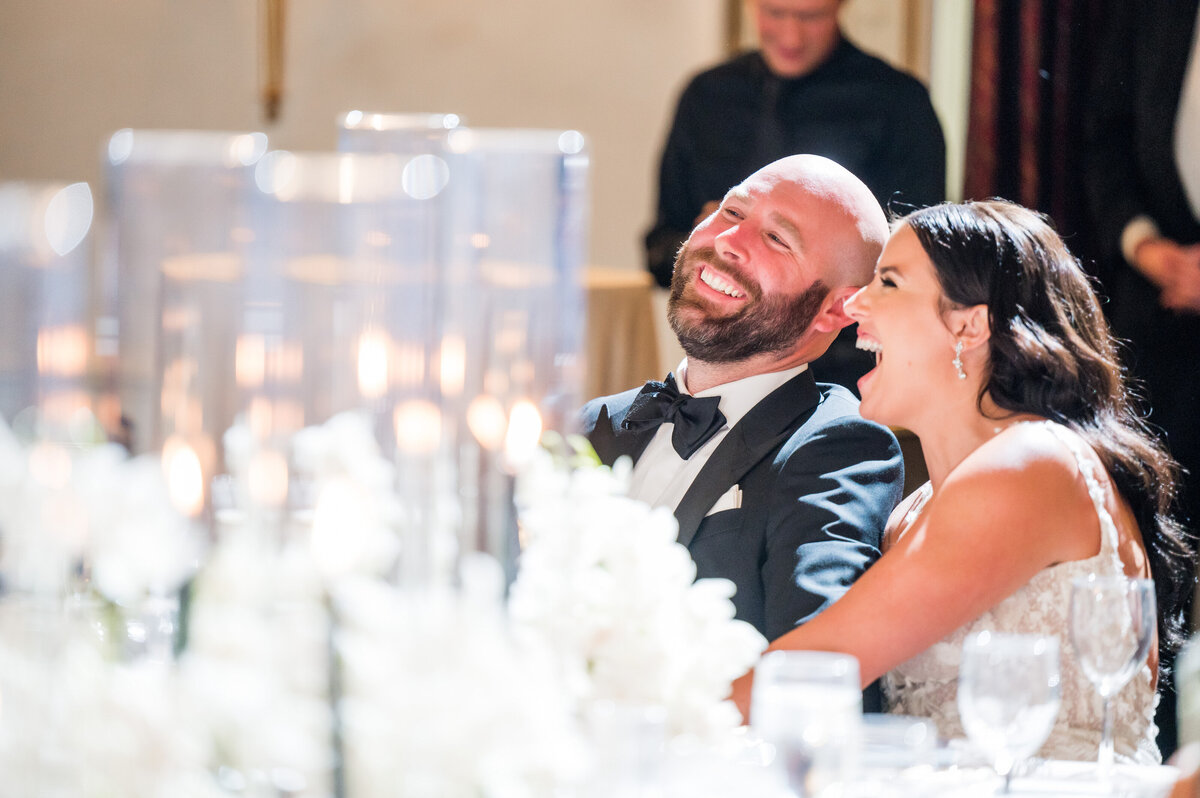 couple laughing during wedding reception