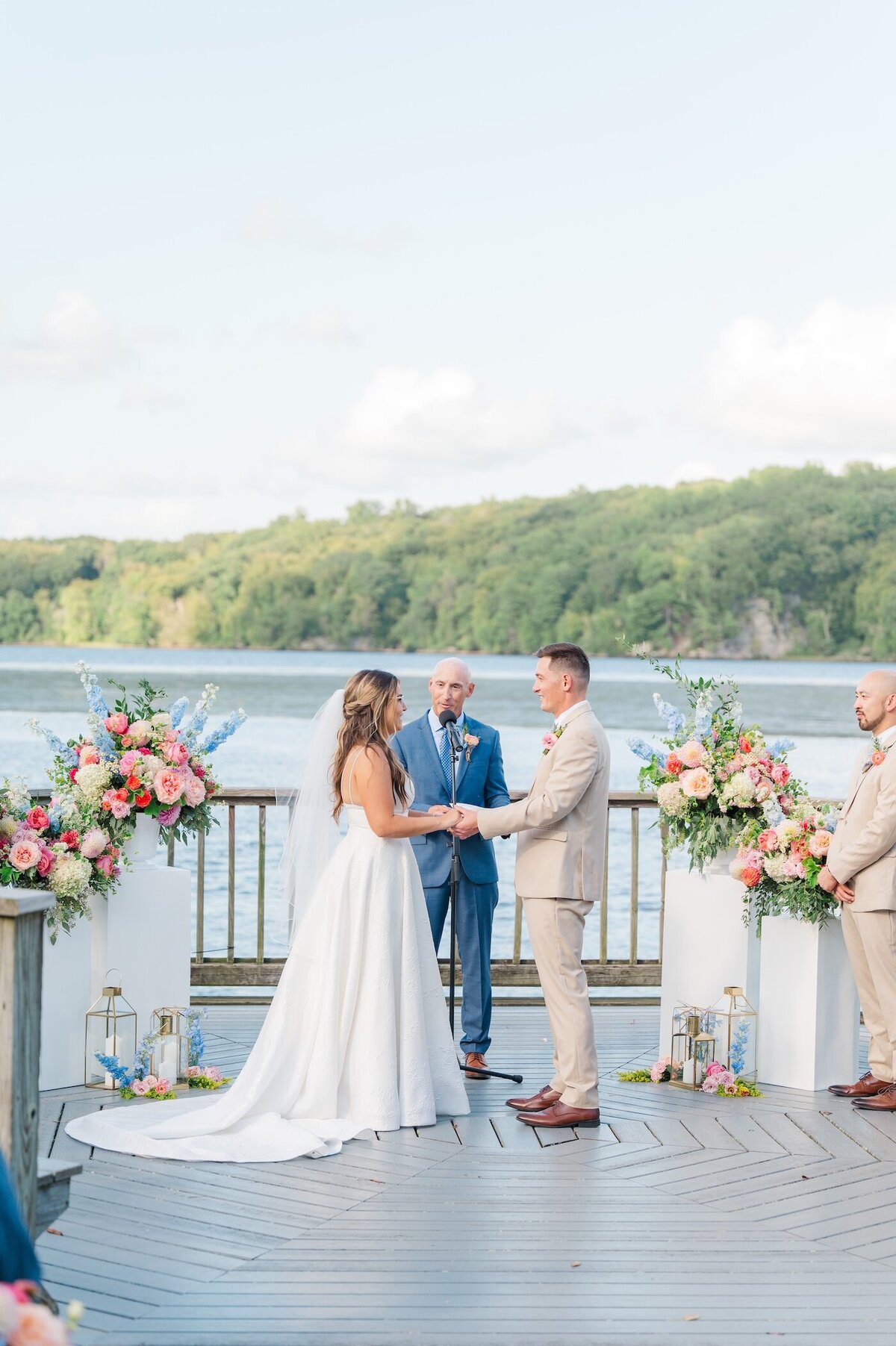 A bride and groom stand during their wedding ceremony at the Lace Factory. 