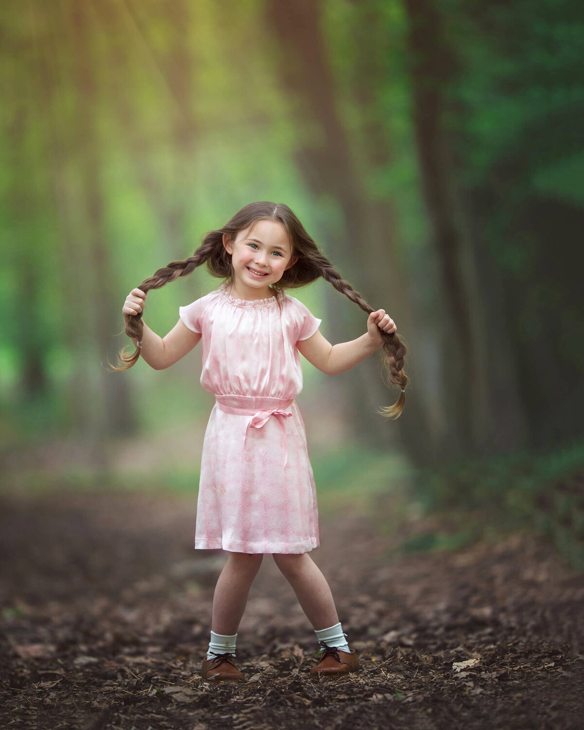 Little girl holding her pigtails in the park - Los Angeles Children’s Photographer