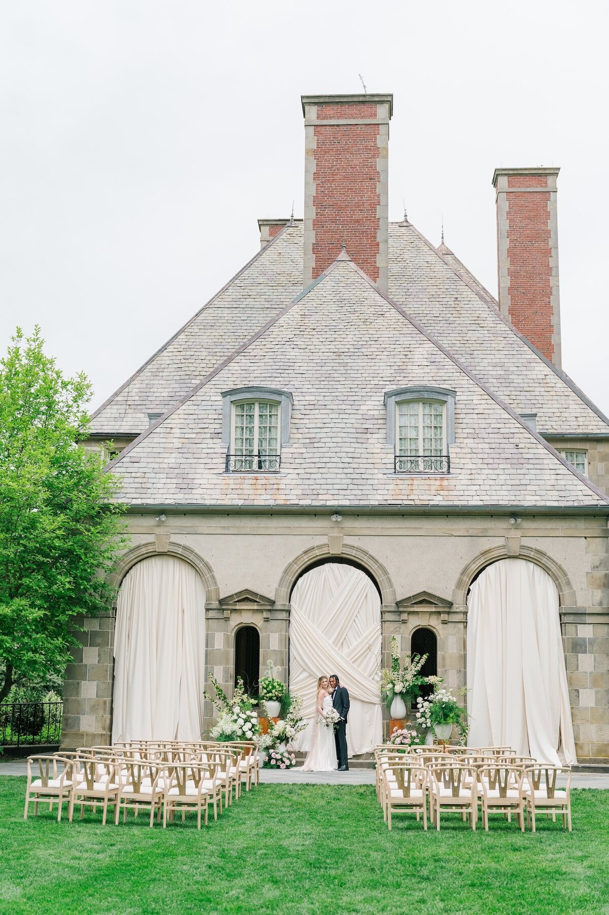 A couple smiling at one another outside of Glen Manor House