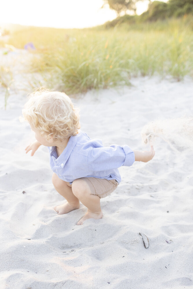 toddler boy playing in the sand