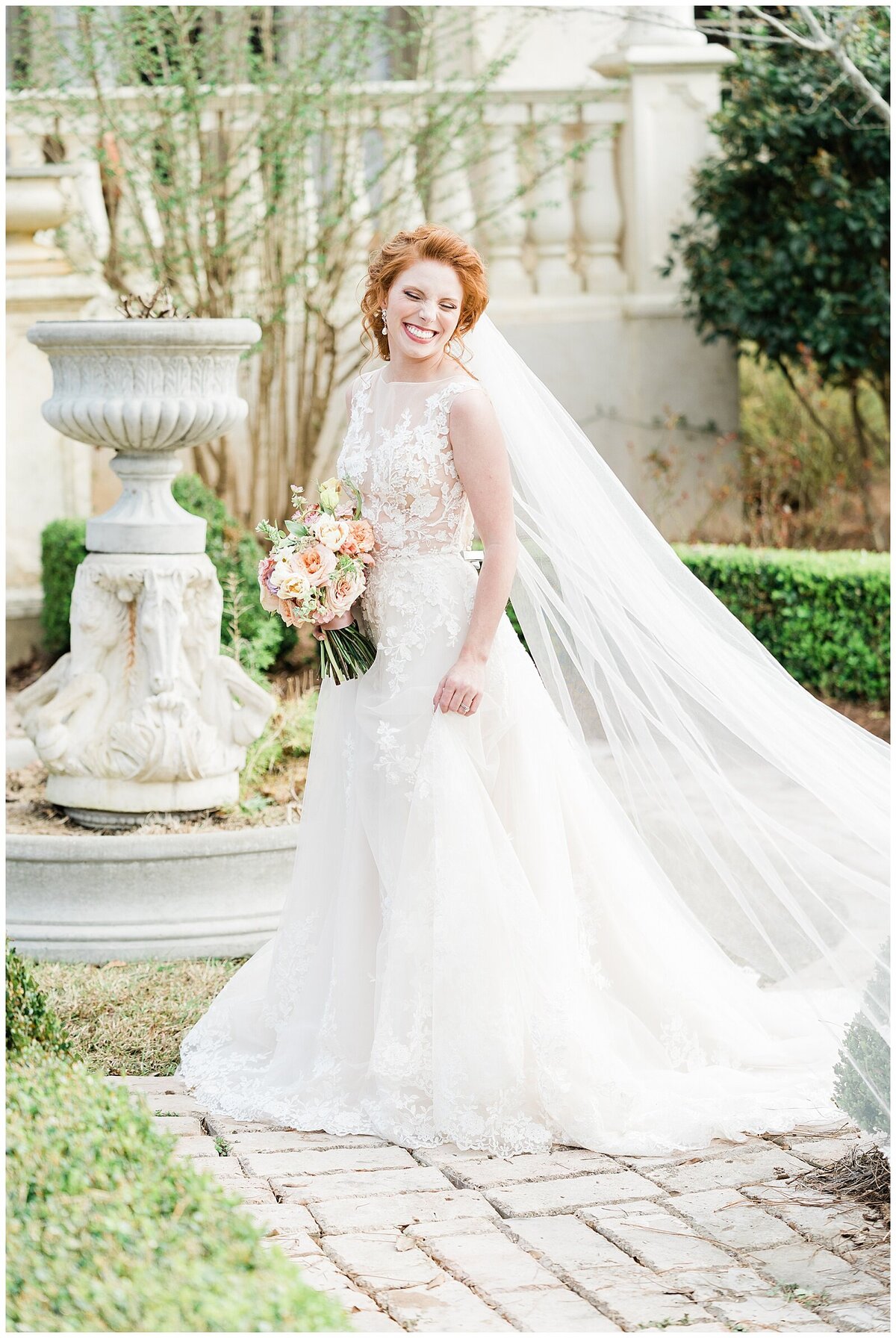 Bride with red hair posing in garden in Alabama