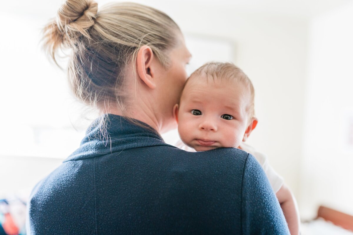 newborn-held-by-parent-relaxed-in-home-session