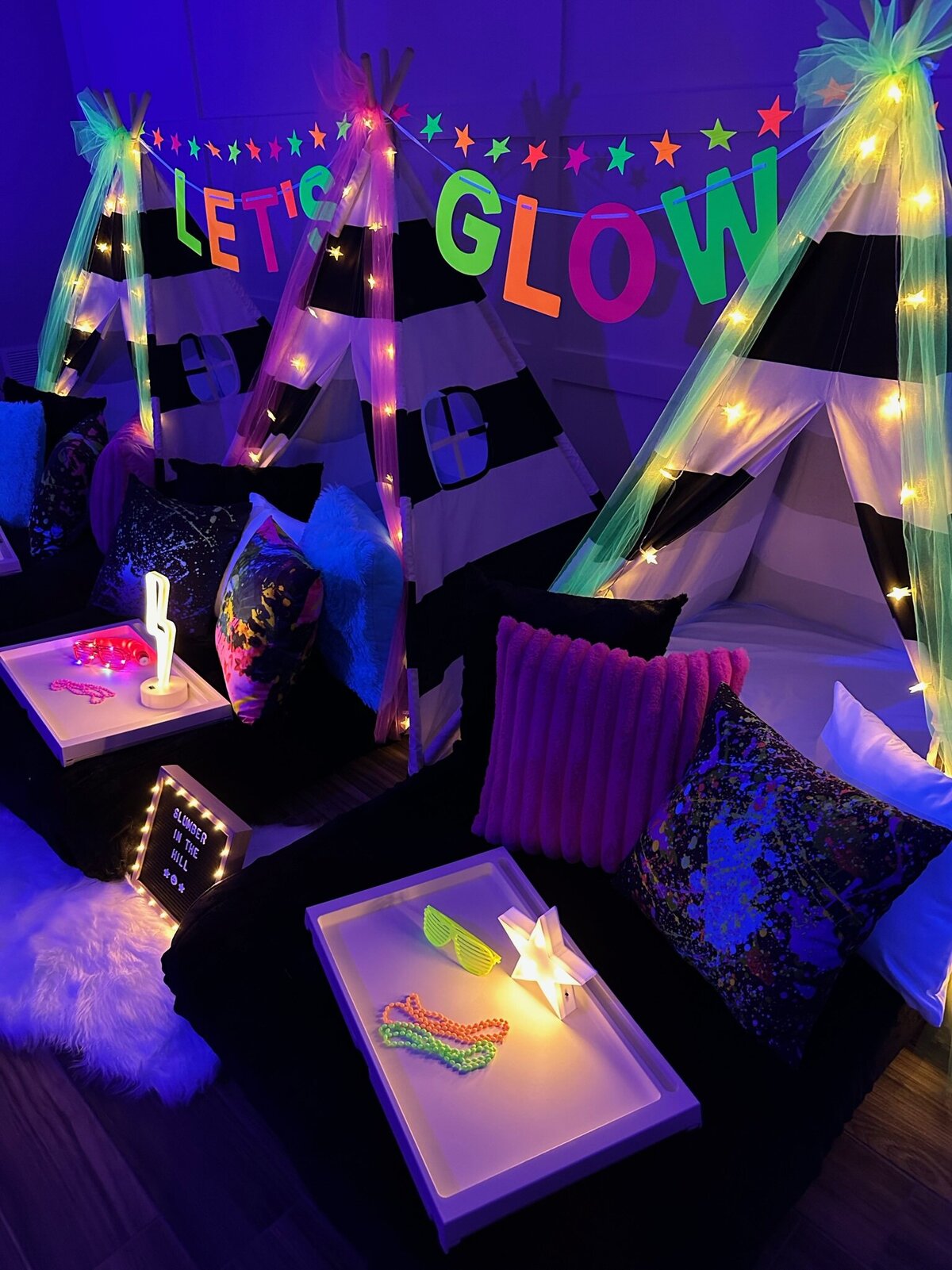 glow in the dark slumber party decor with teepee beds
