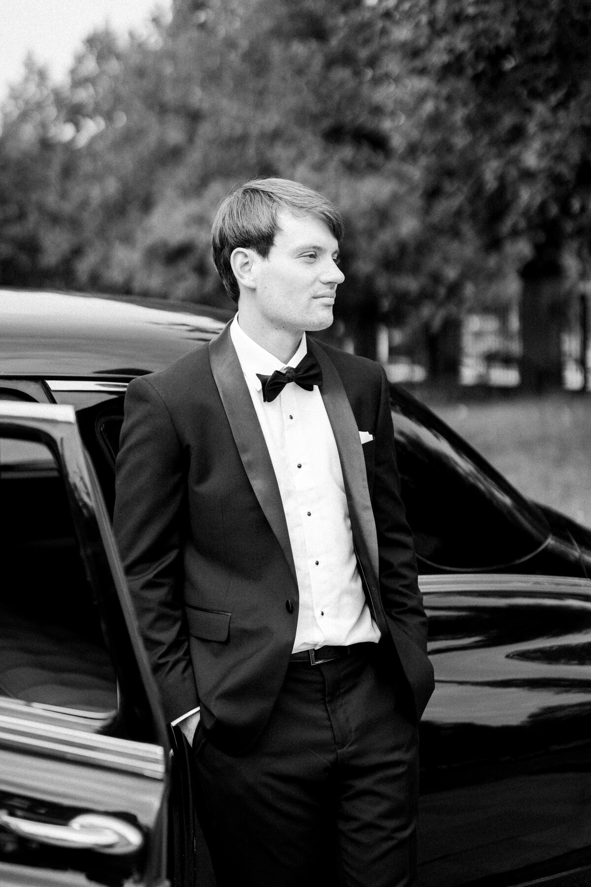 Groom next to vintage car