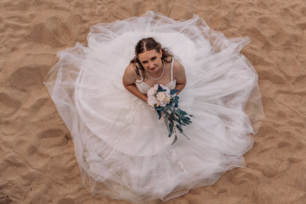 townsville bride showing off her wedding gown on the beach - Townsville Wedding Photography by Jamie Simmons