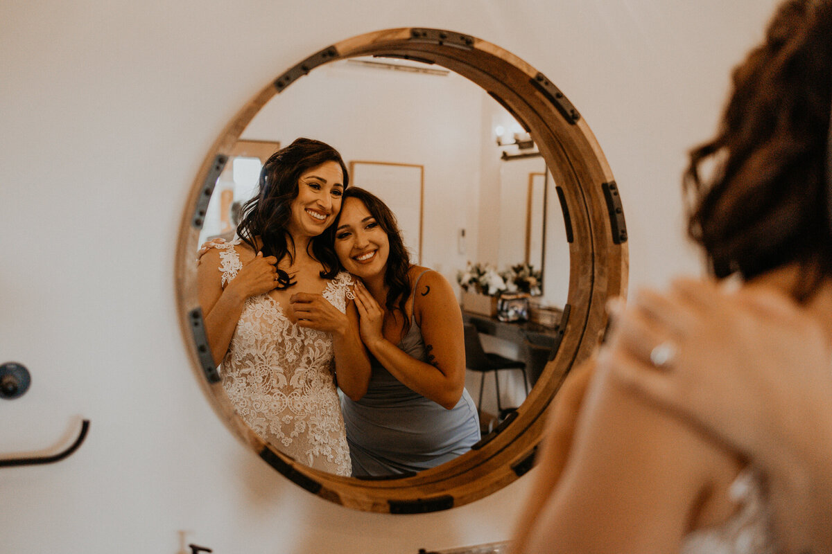 bride getting ready with her sister