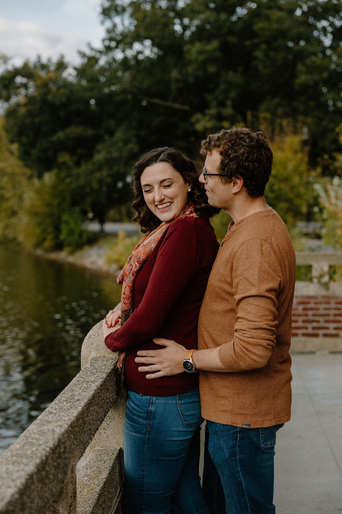 man holding woman near pond
