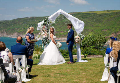 A bride and groom standing at the end of their wedding ceremony