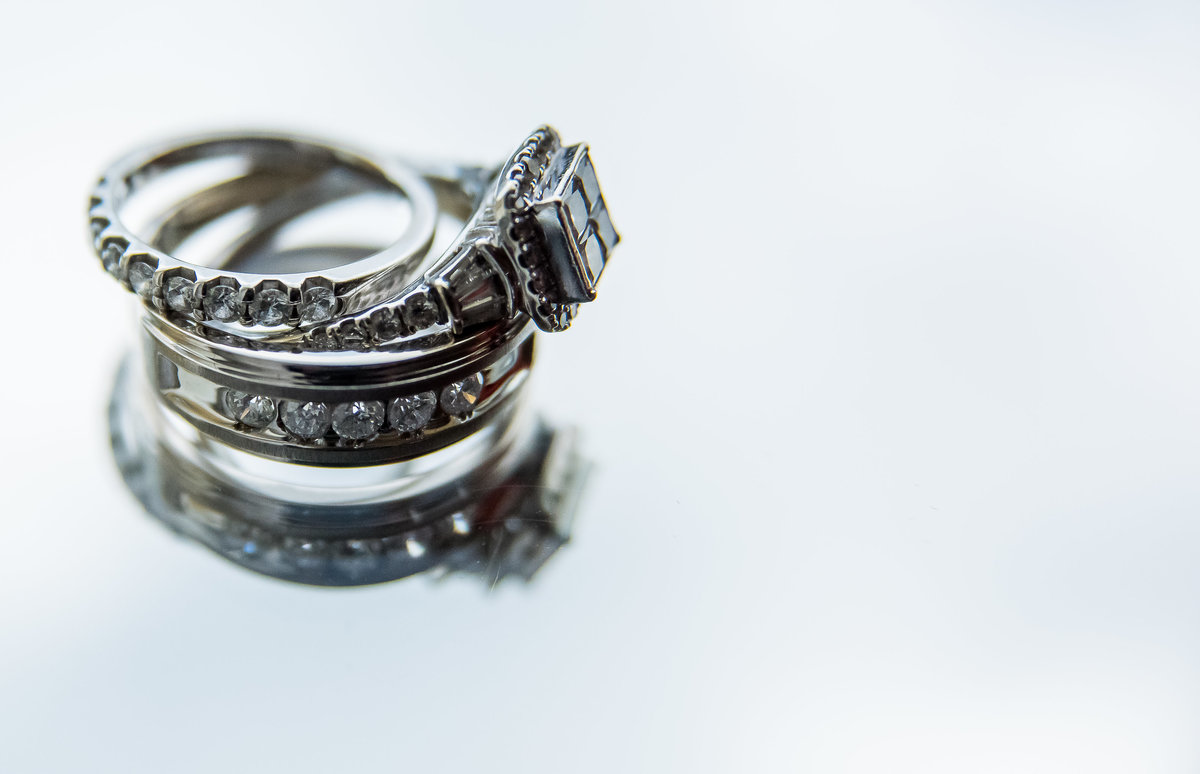wedding rings on reflective surface