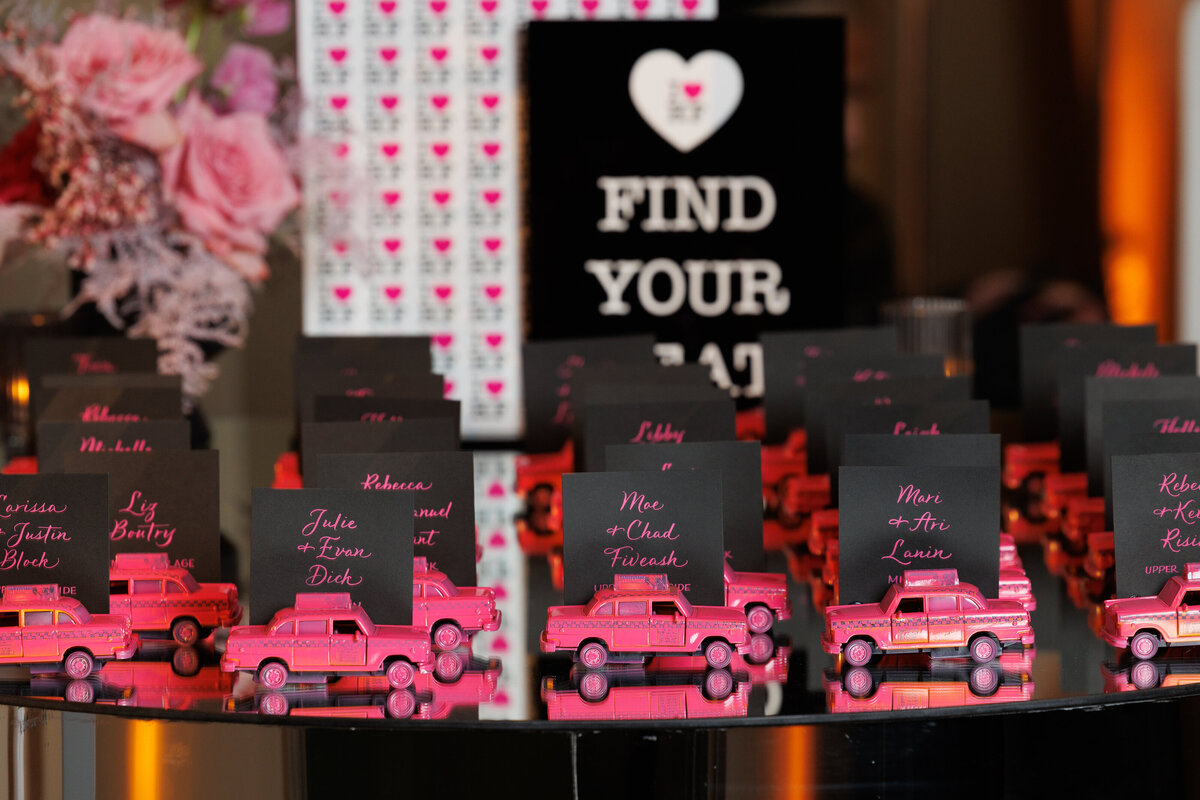 Small pink cars laid out on a table