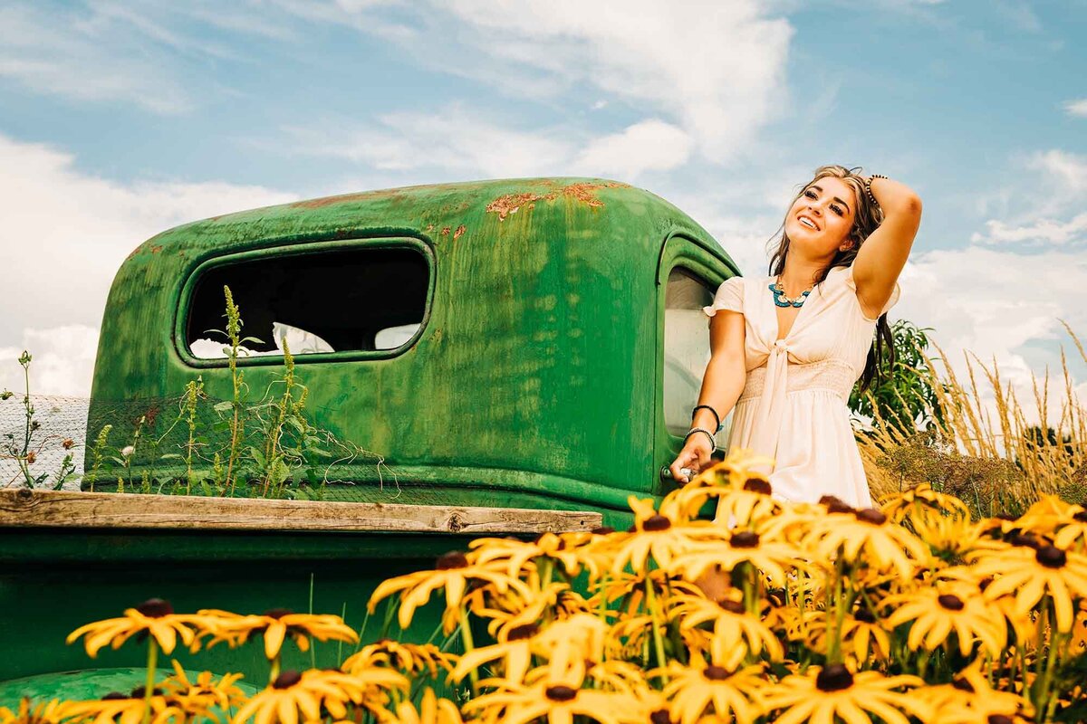 Senior photo of girl on antique truck with sunflowers, Turner Farms, Missoula