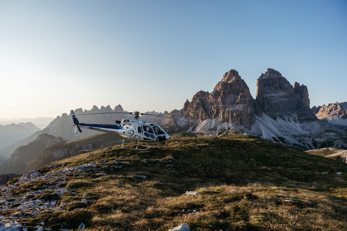 Helicopter flying over Dolomites peaks