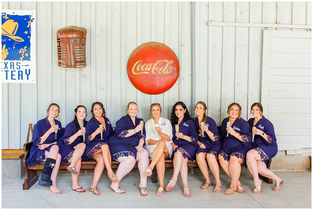 bride and bridesmaids group photo holding champagne glasses