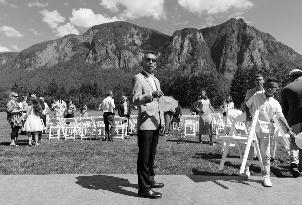 Wedding guests stand in front of mountains in Snoqualmie, Washington.