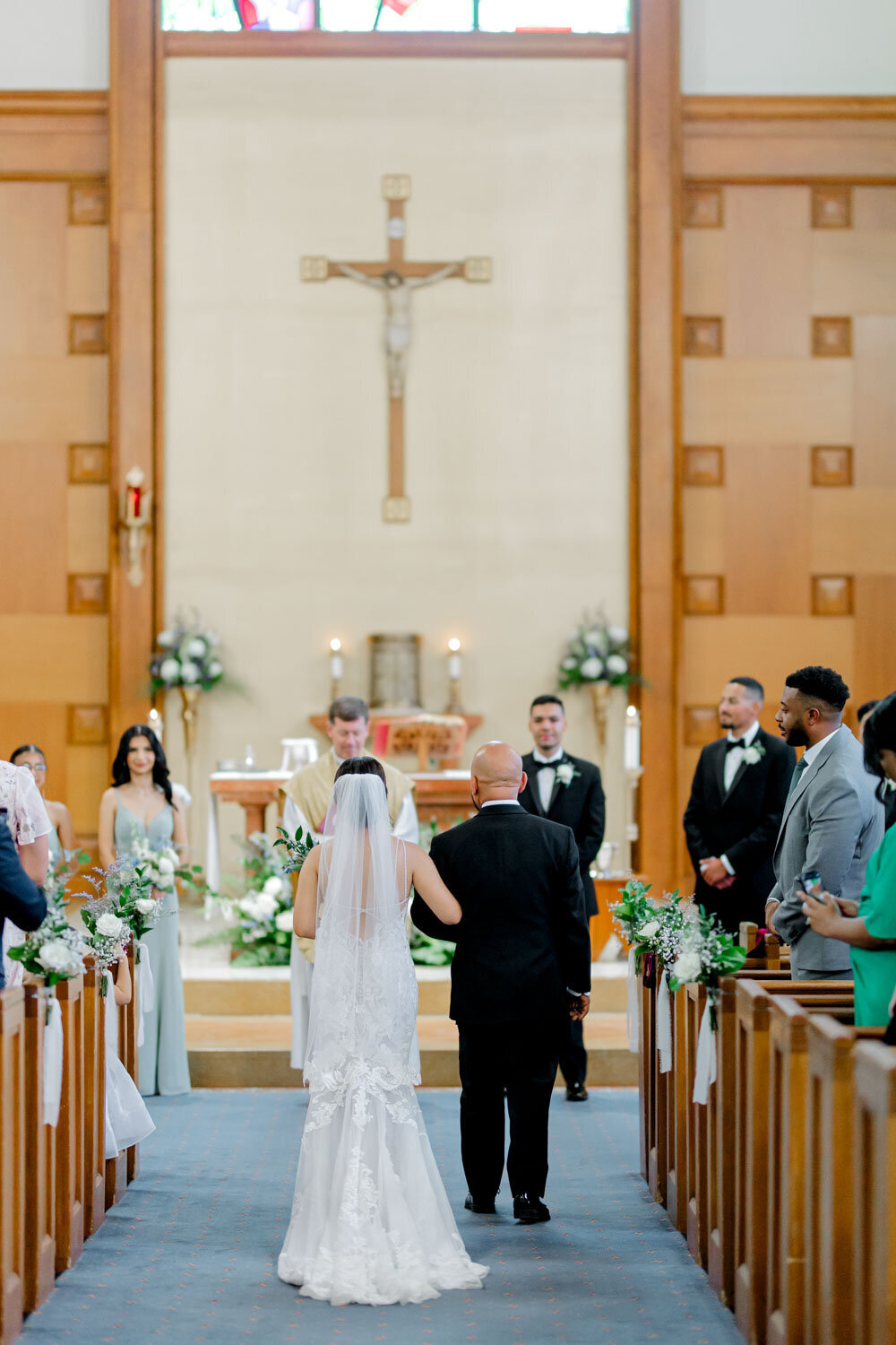 Bride and father walking to the wedding altar