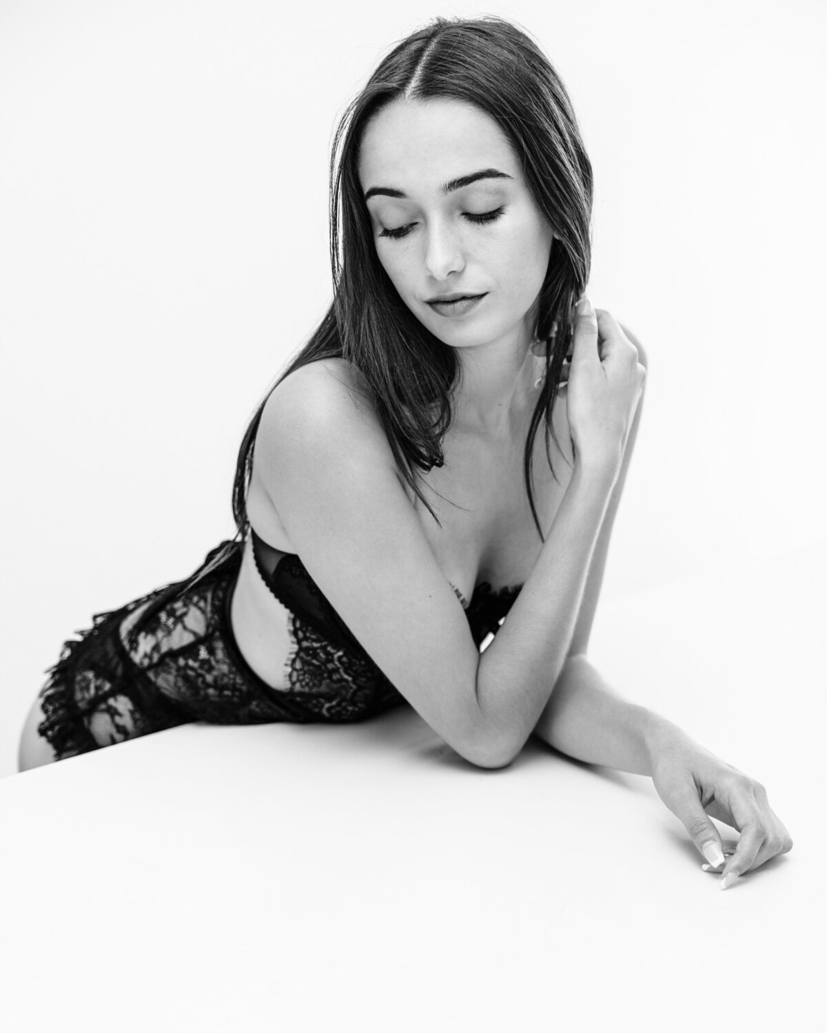 High key black and white boudoir portrait woman long hair