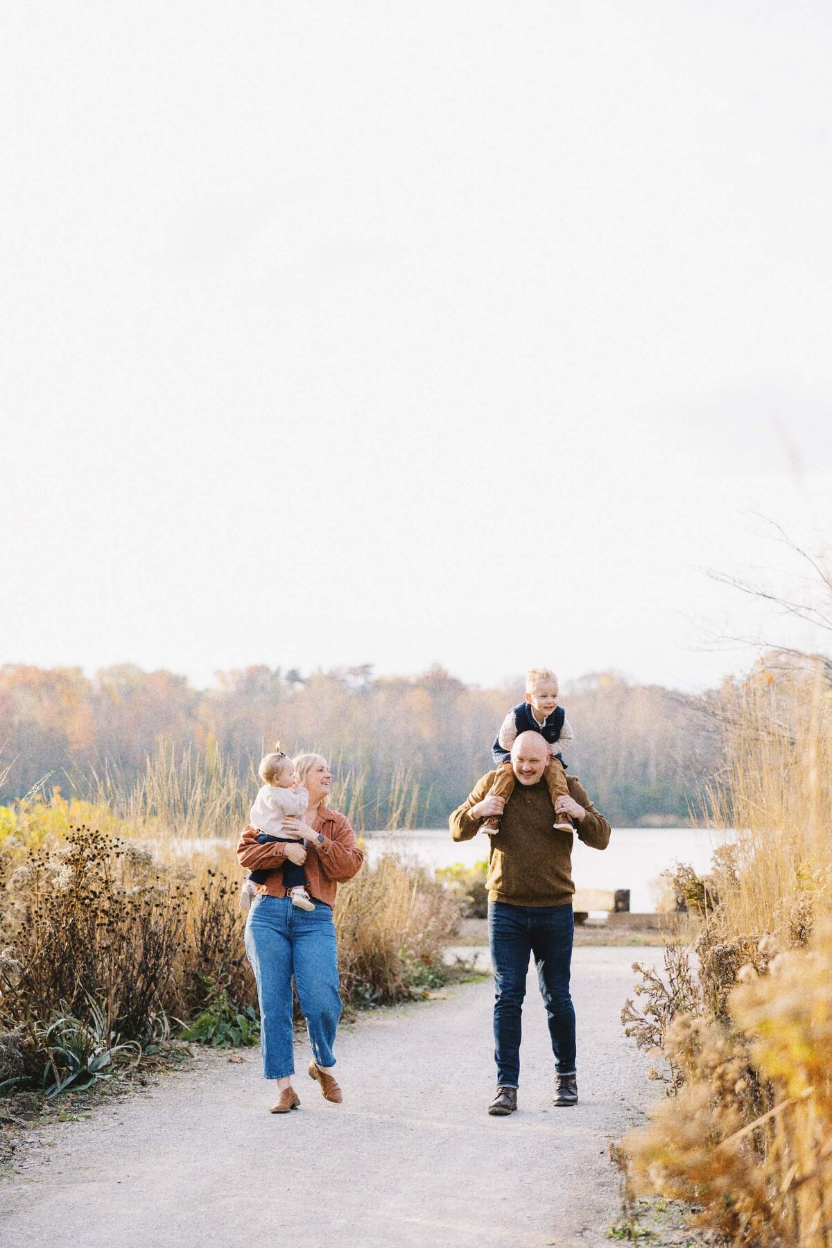family walking and laughing down a gravel path