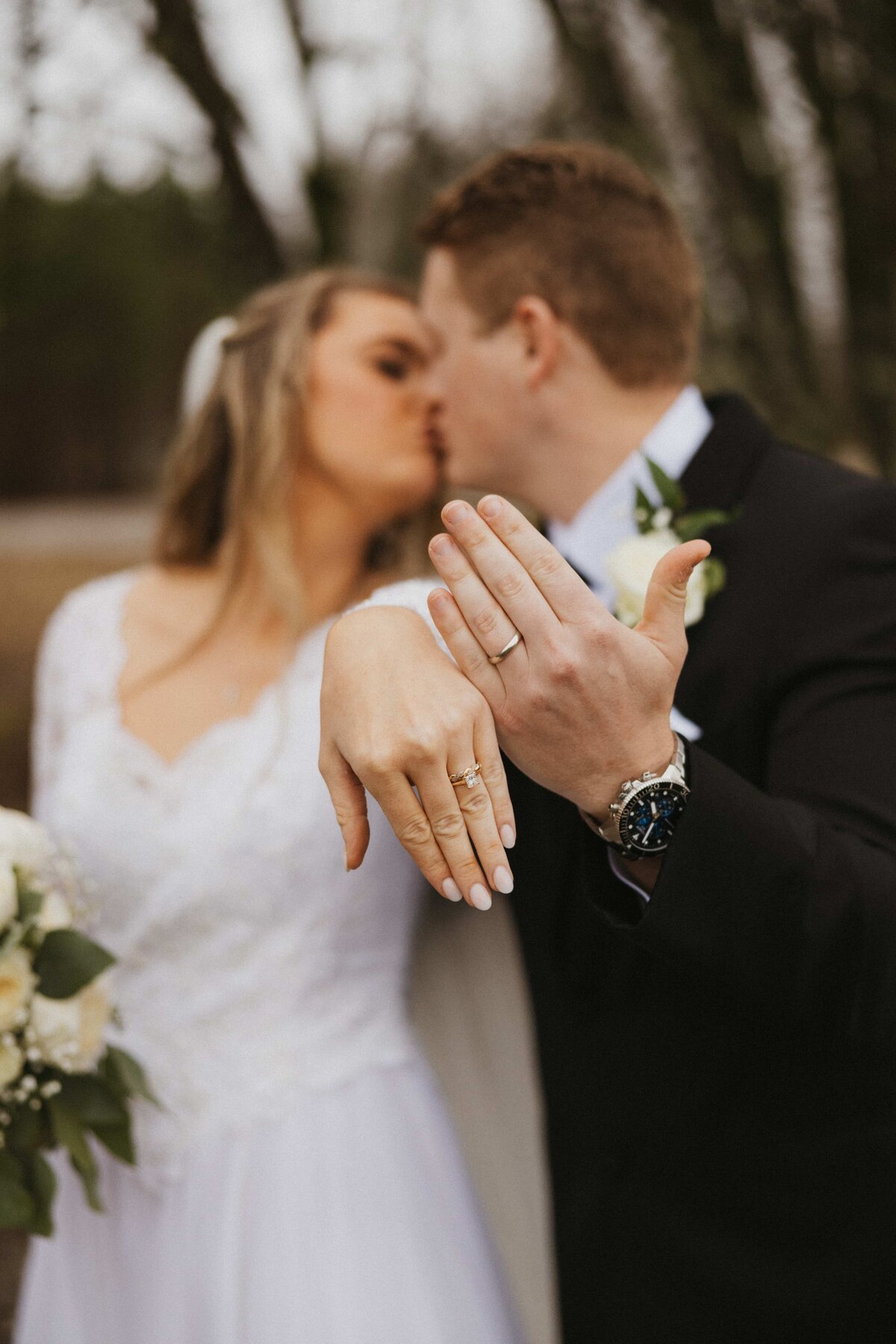 bride and groom showing off rings