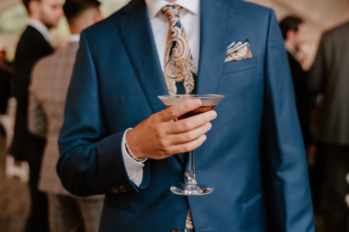 Guest holding drink in hand during reception.