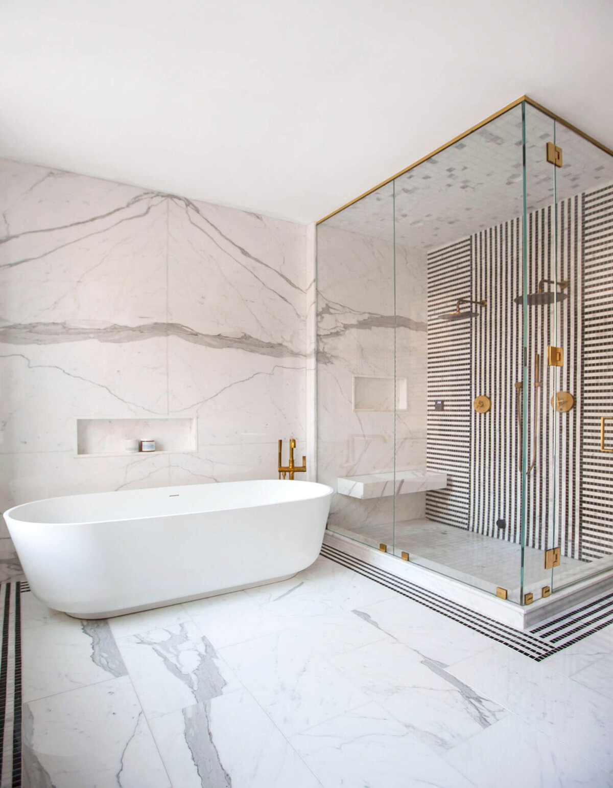 Modern and stylish neutral  bathroom with tub and shower with gold accents