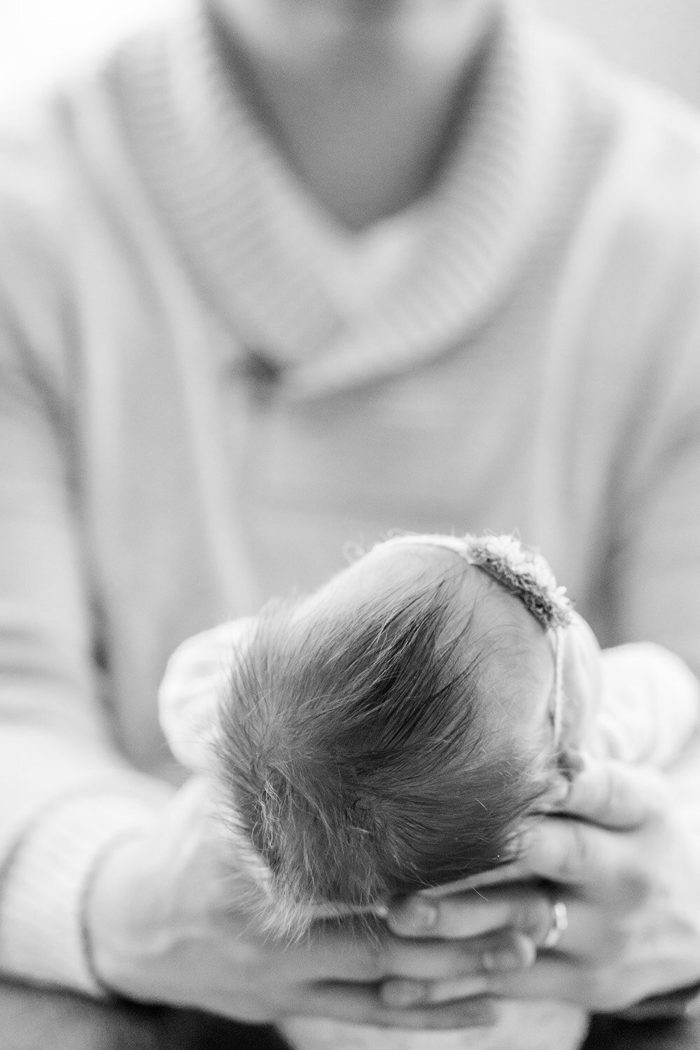 dad holding baby's head during lifestyle newborn pictures in Fairfax, Virginia