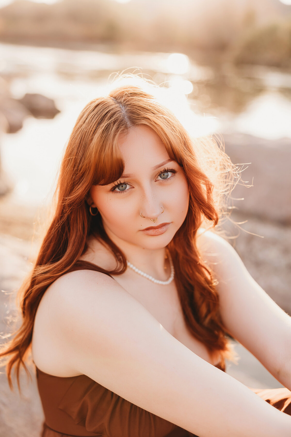 Girl with red hair posing at salt river for senior session by phoenix photographer