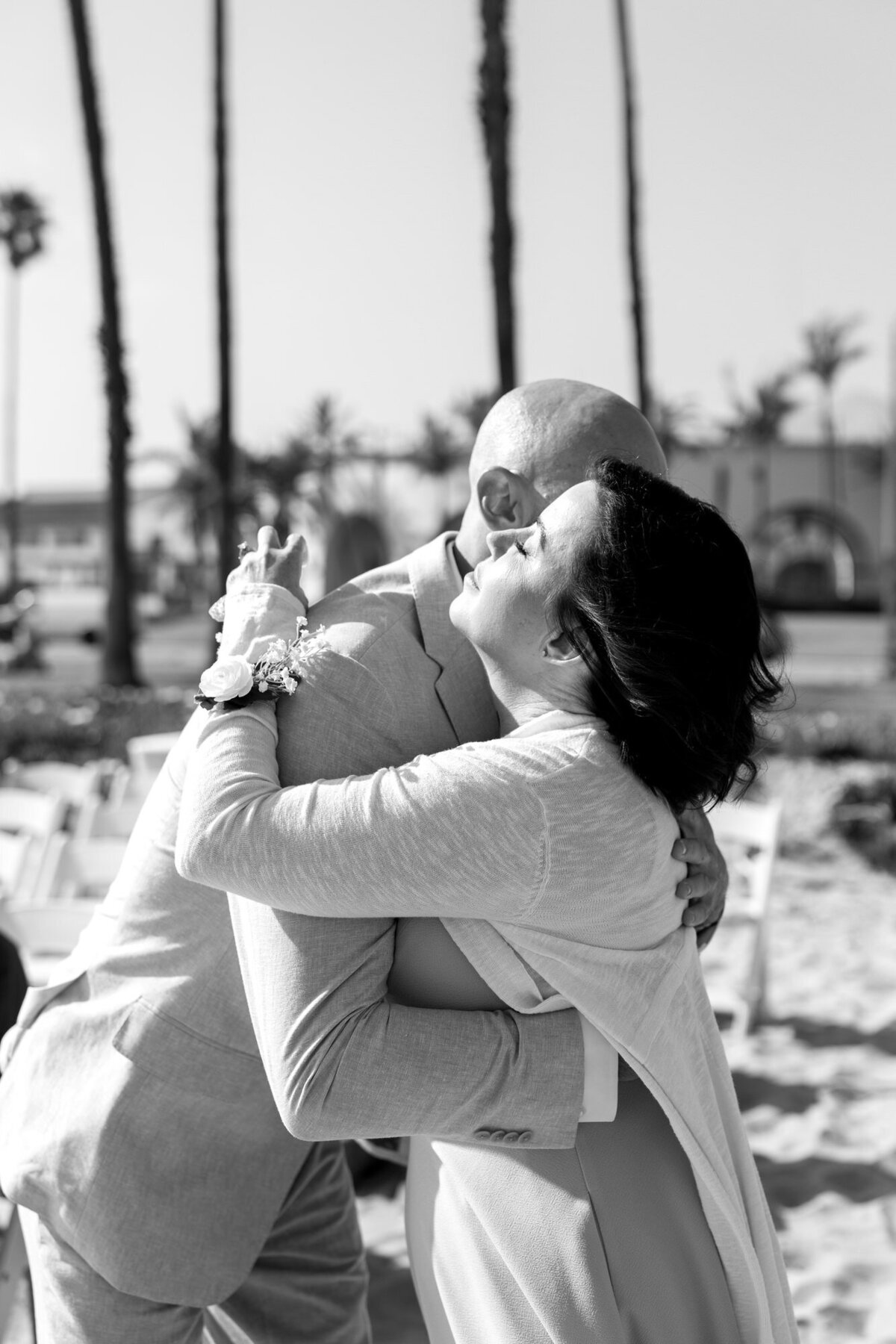 Groom and mom hugging during ceremony at Hilton Beachfront Resort Santa Barbara