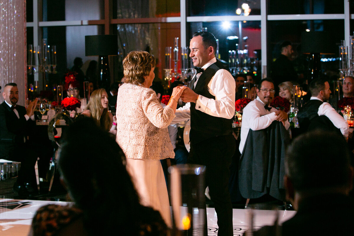 A groom and his mother dancing at his wedding