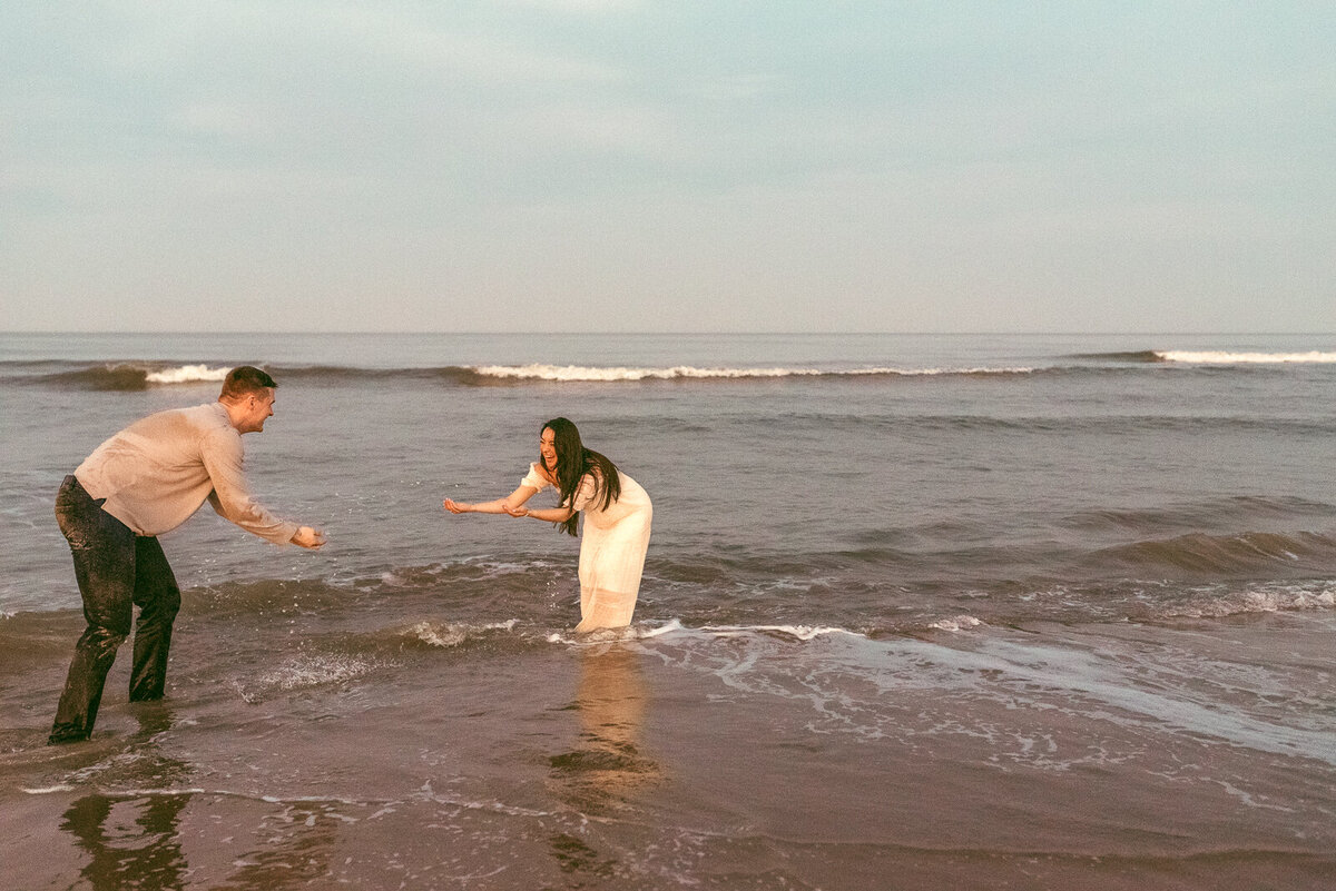 couple-playing-in-the-water-virginia-beach