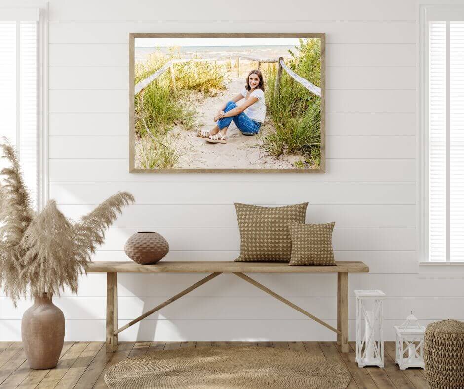 gorgeous senior photo taken by Ashley Kalbus Photography framed and hung above a bench in an entry way
