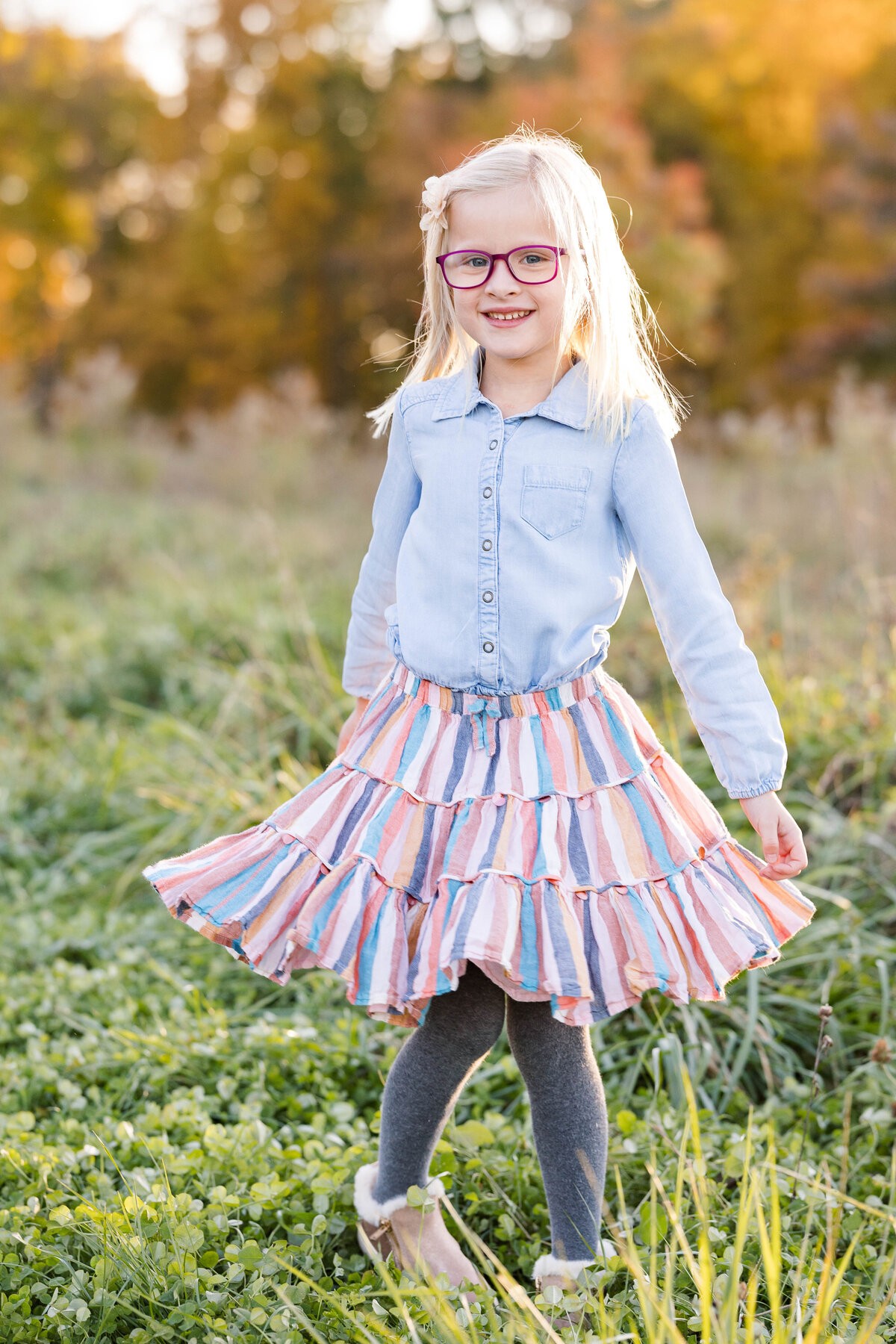 photo of little girl standing in a field