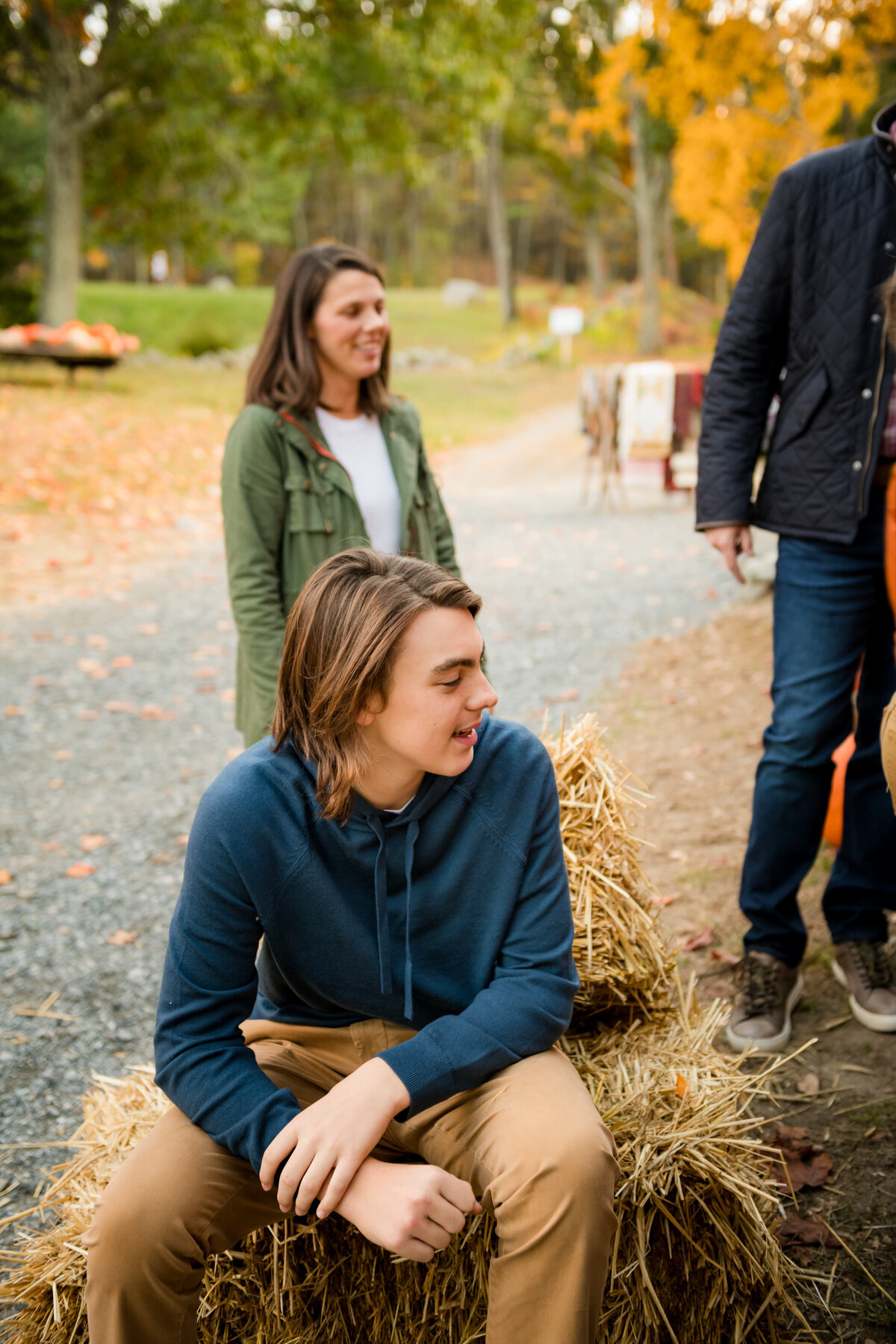 boy sitting on hay bale