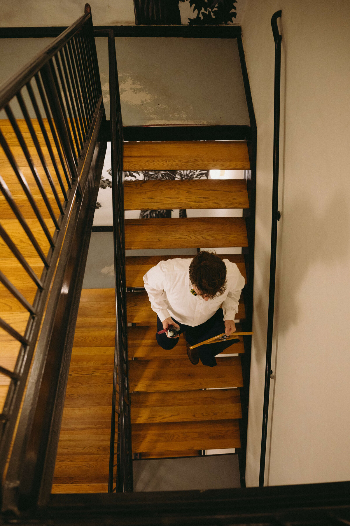 groomsman walking down wooden stairs for a Richmond weddings