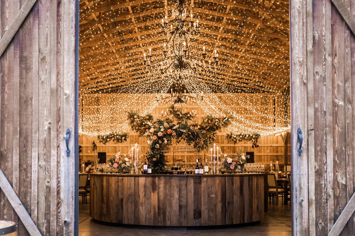 Gorgeous autumnal floral clouds hang over the dance floor, including terra cotta, rose gold, toffee, blush, and neutral florals. These clouds feature lush garden roses, ranunculus, lisianthus, and privet berries. Designed by Rosemary and Finch in Nashville, TN.