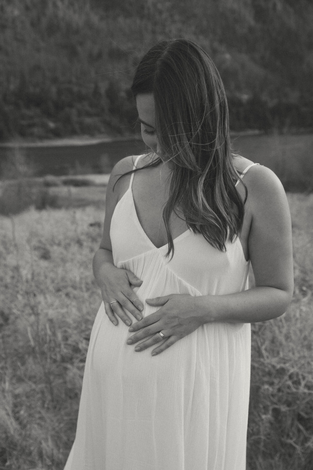 Black and White Woman Holding Hands on Pregnant Belly