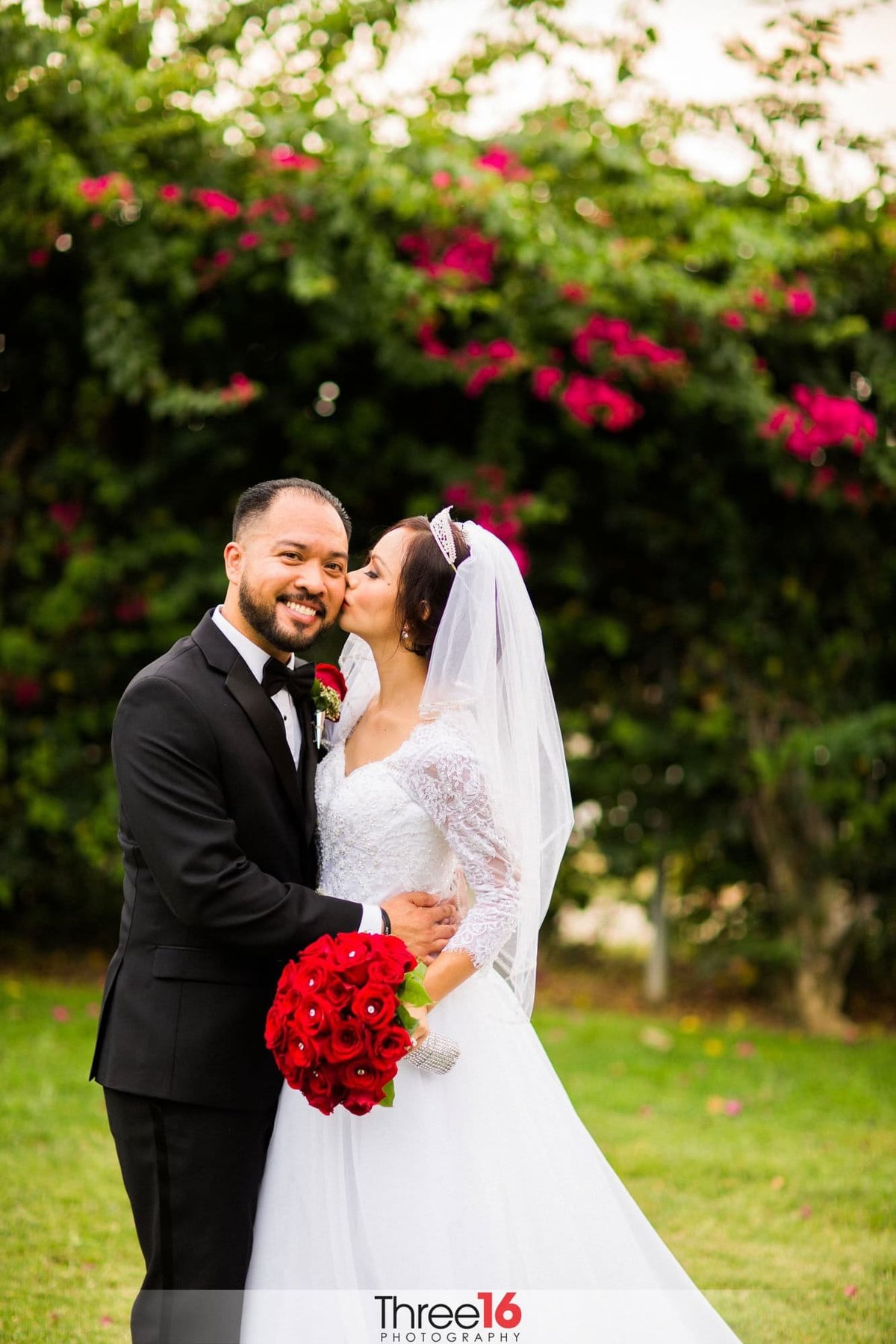 Bride kisses her Groom on the cheek during photo session