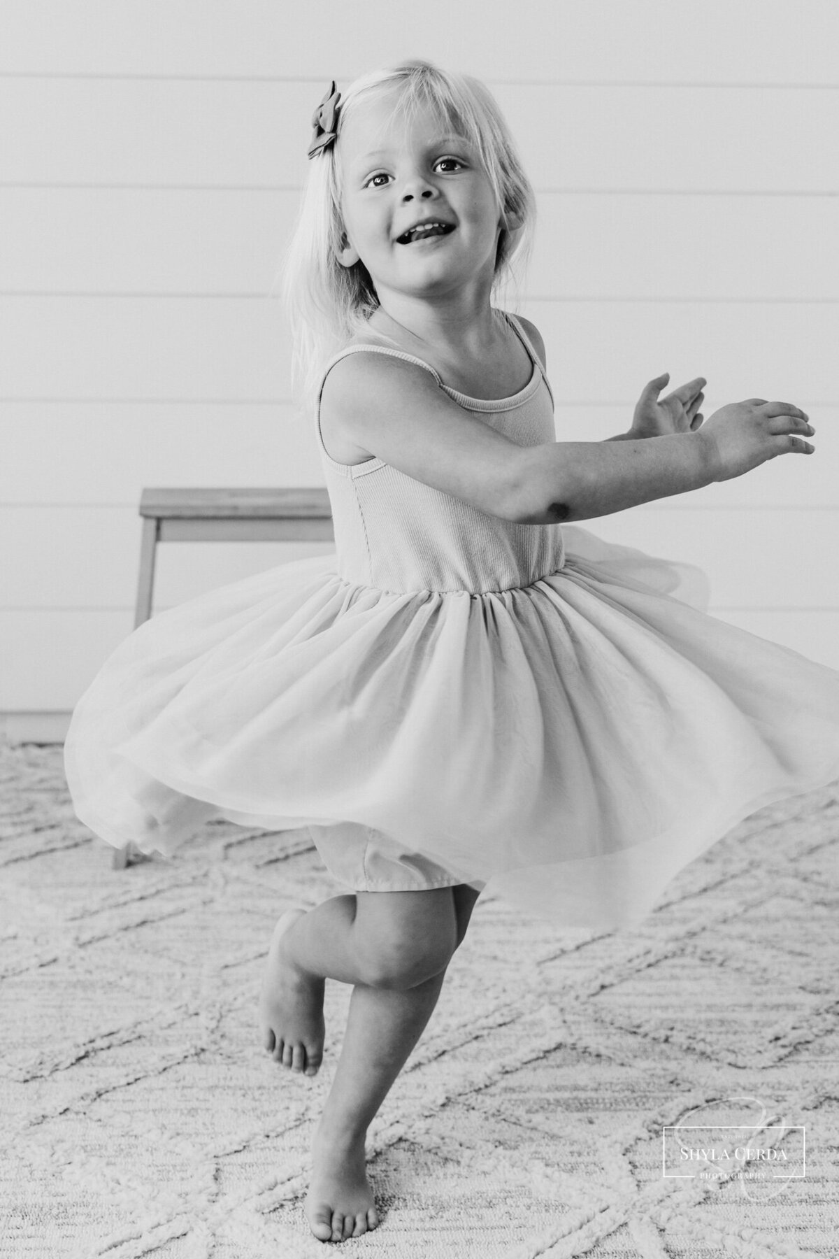 Girl twirling and laughing in studio
