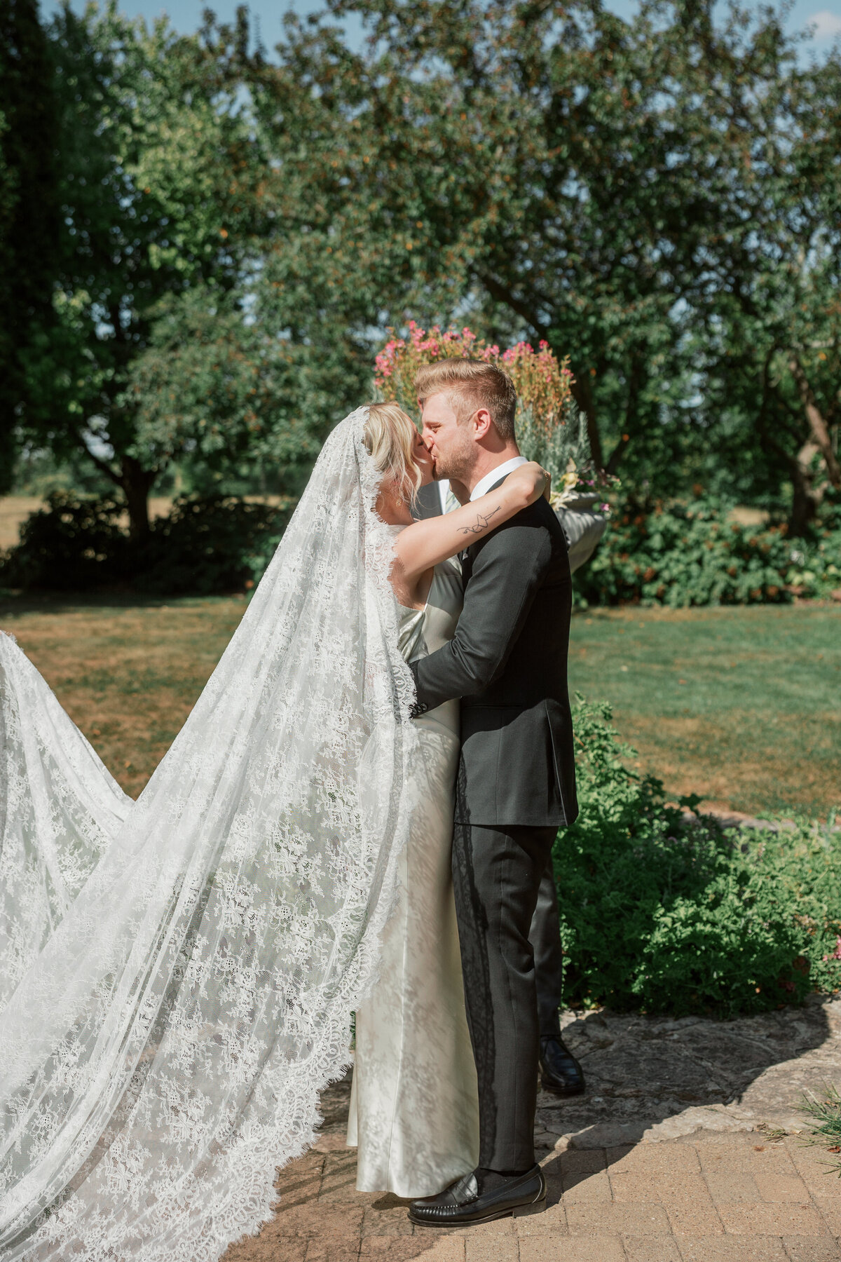 Couple shares first kiss as newlyweds during elegant Dayton ceremony, captured by Philadelphia wedding photographer.