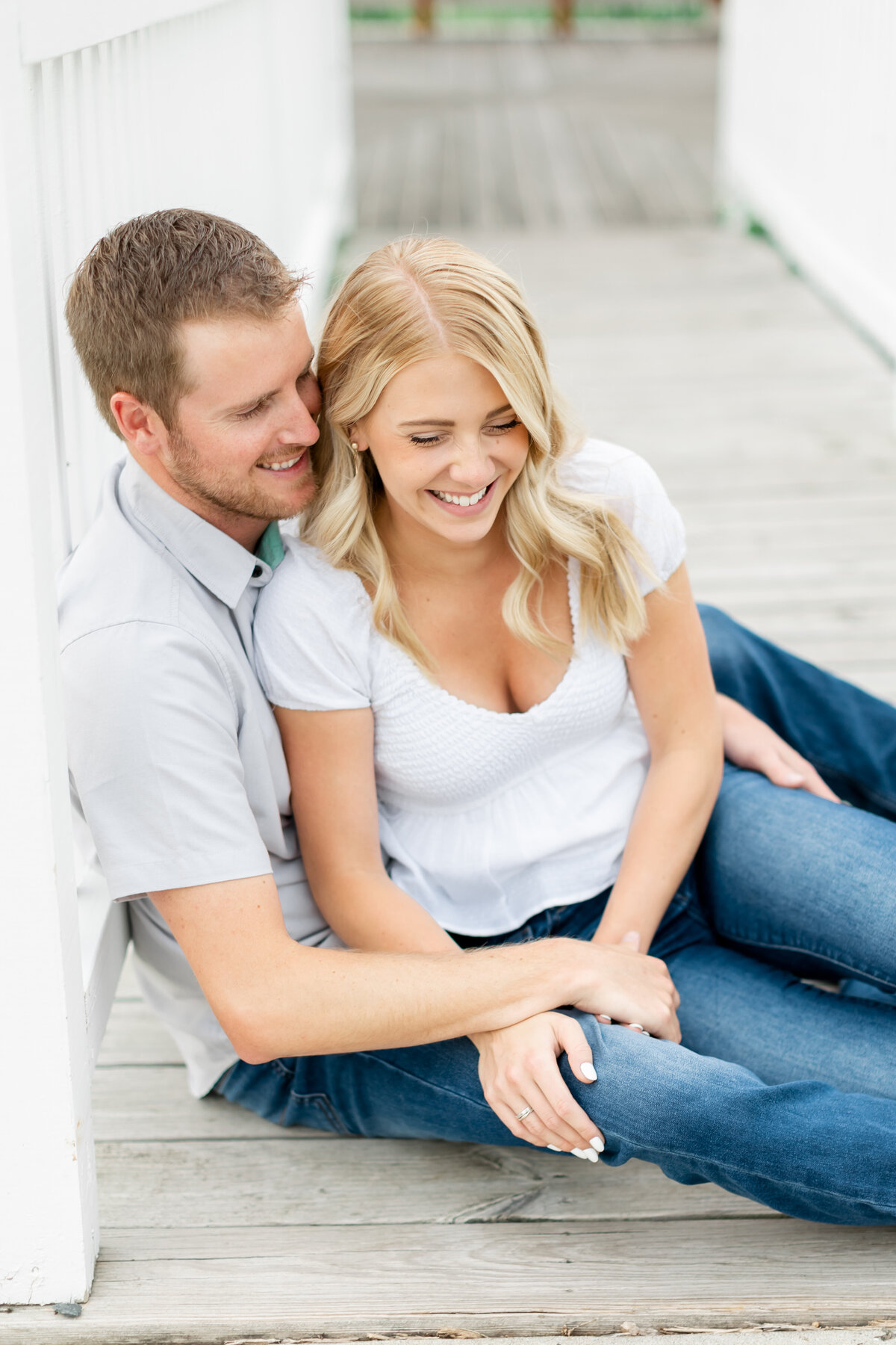 couple cuddling sitting on the ground taken by one of the best orlando wedding photographers