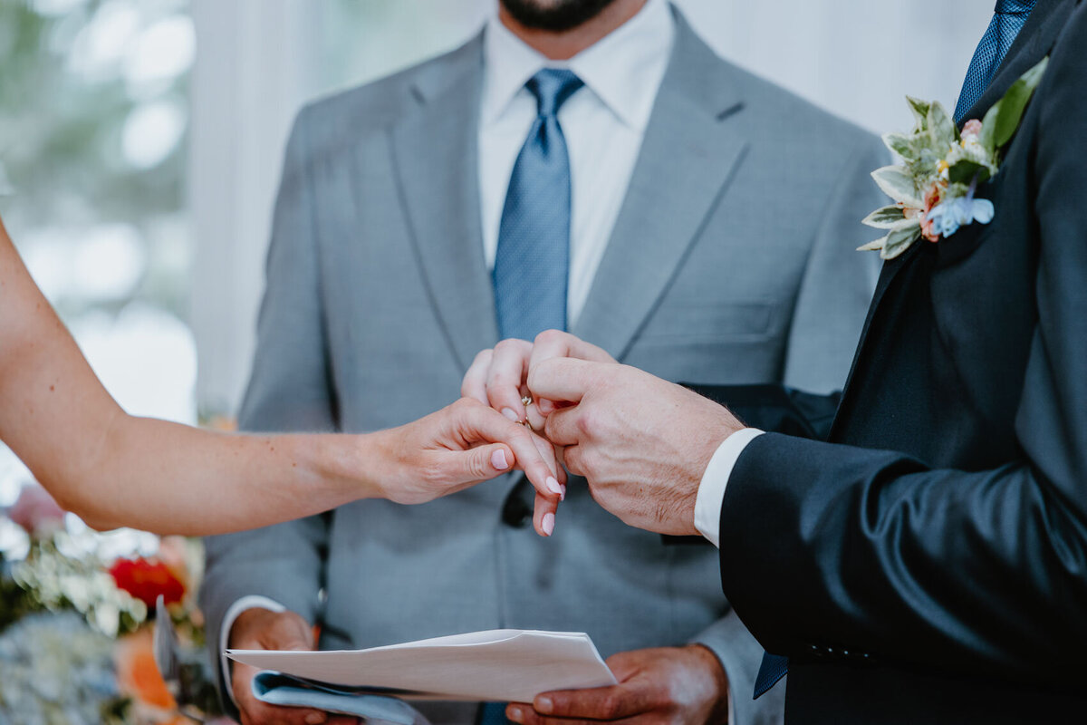 Close-up shot of a couple exchanging rings. Boston Wedding Photographer