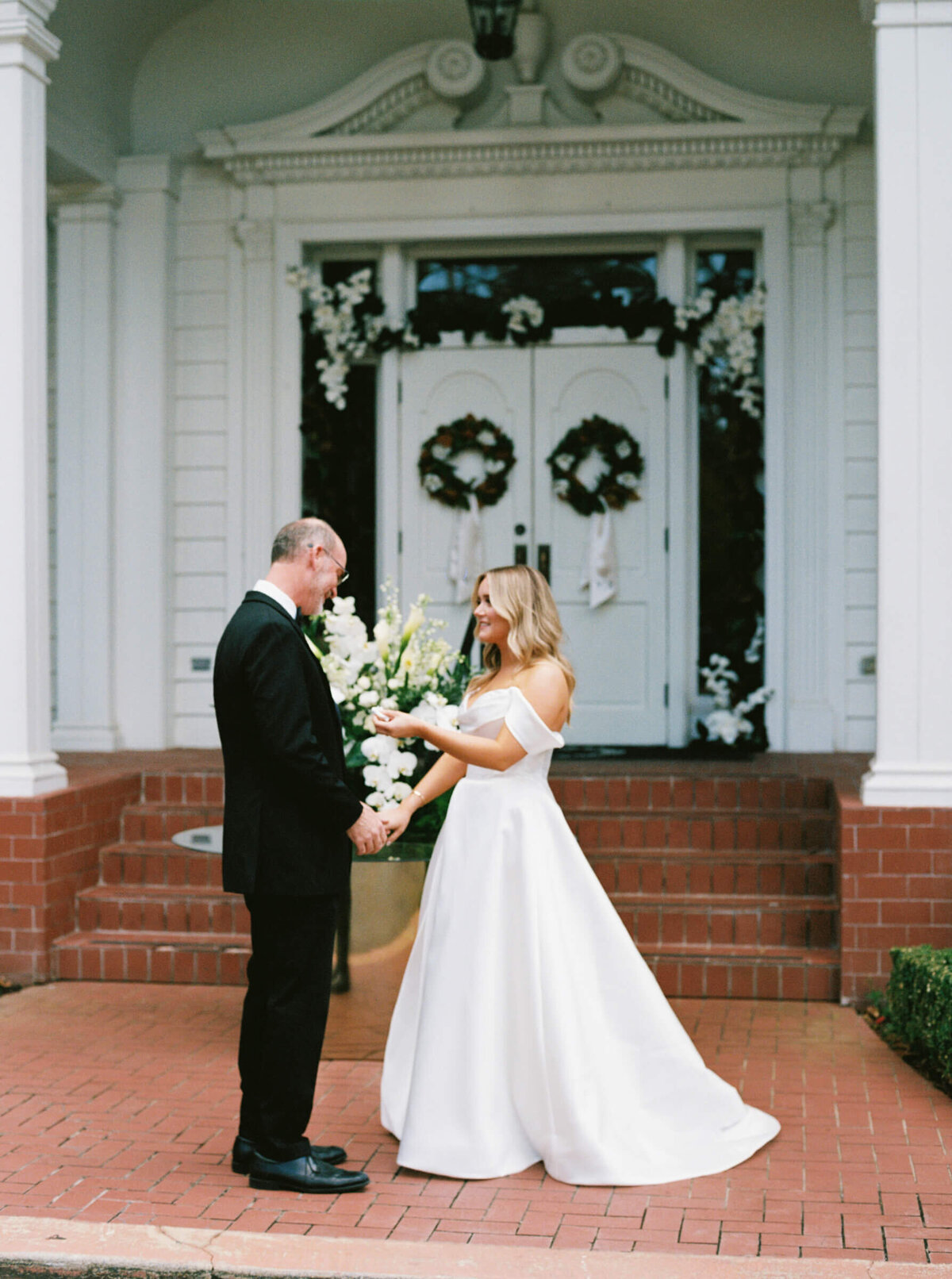 A wedding day photo of the brides dad seeing her for the first time in her dress