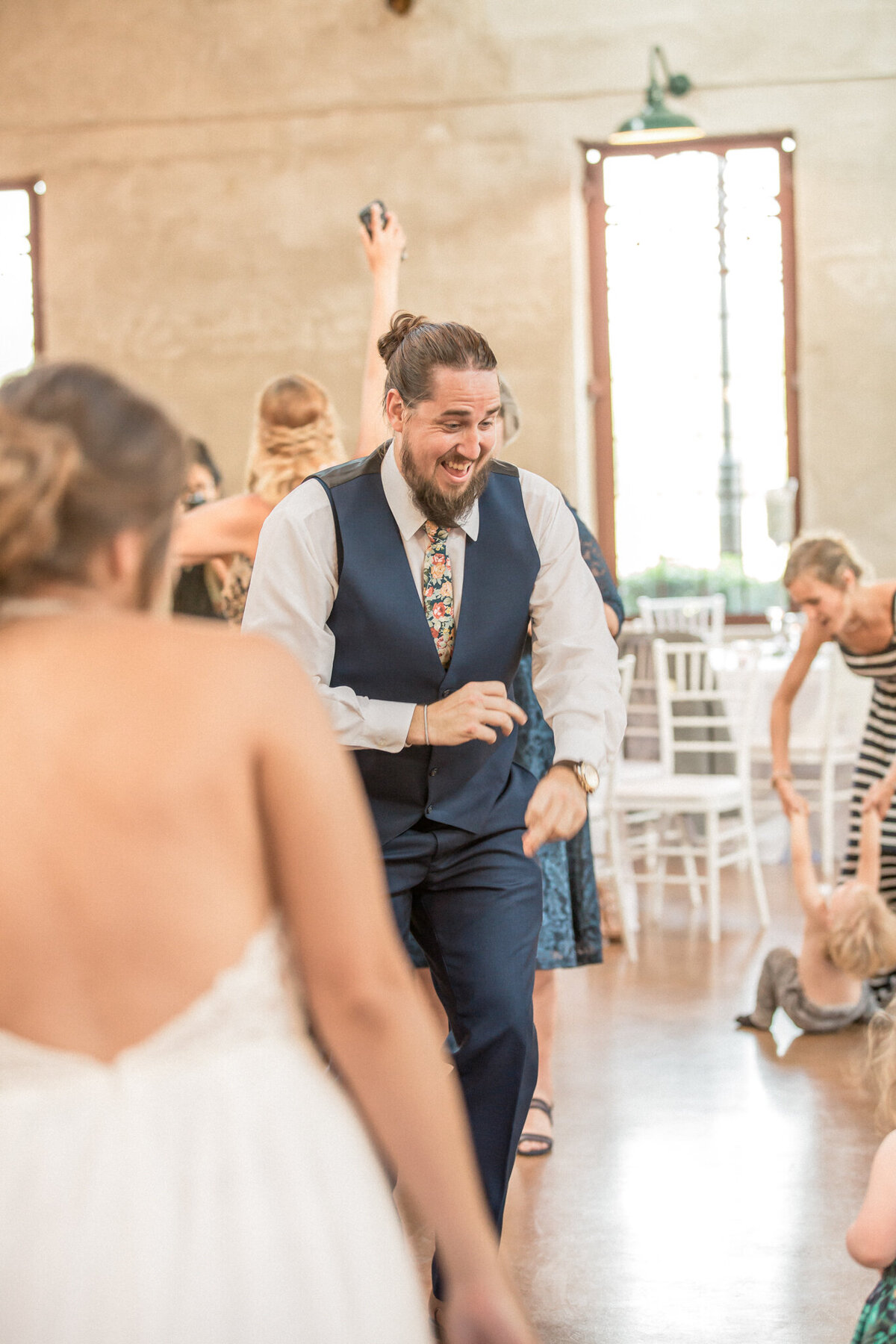 the brides brother, a groomsman, dances during the reception