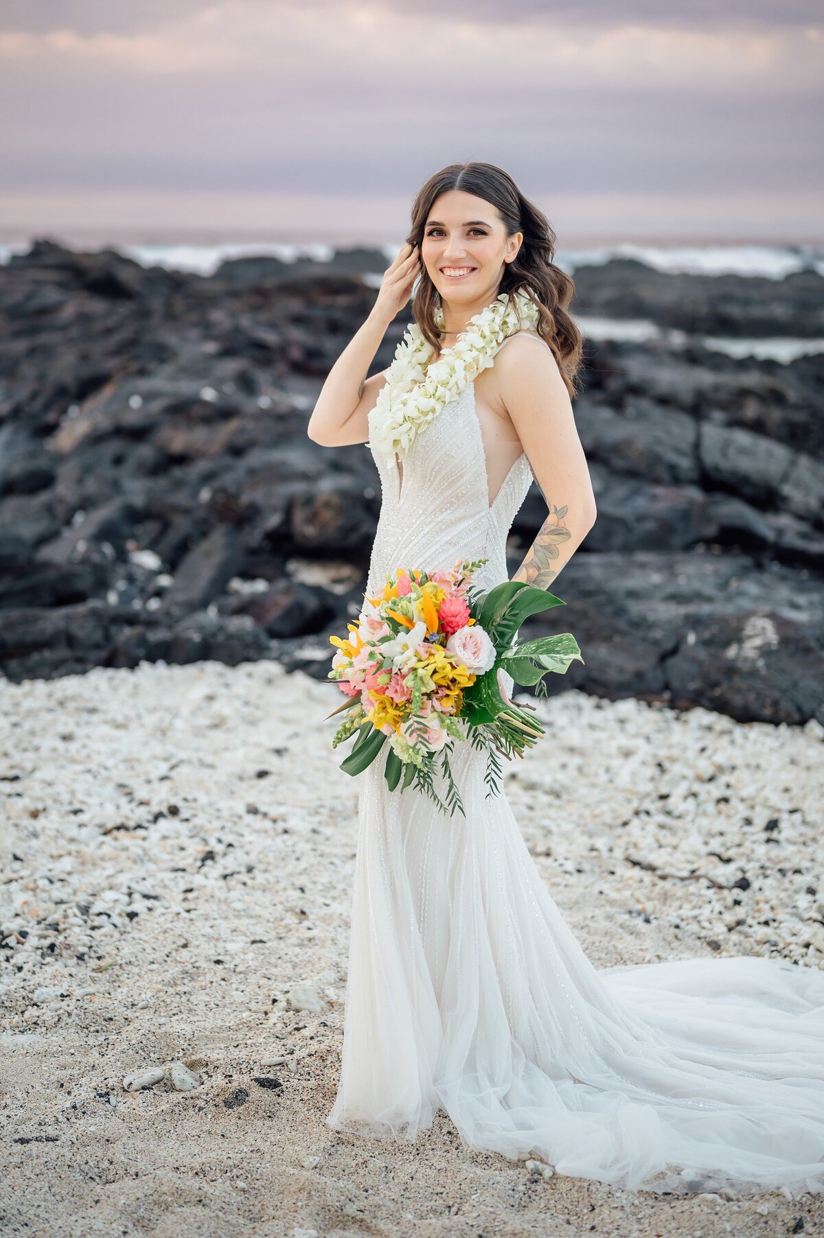 stunning bride in her luxurious dress and tropical bouquet