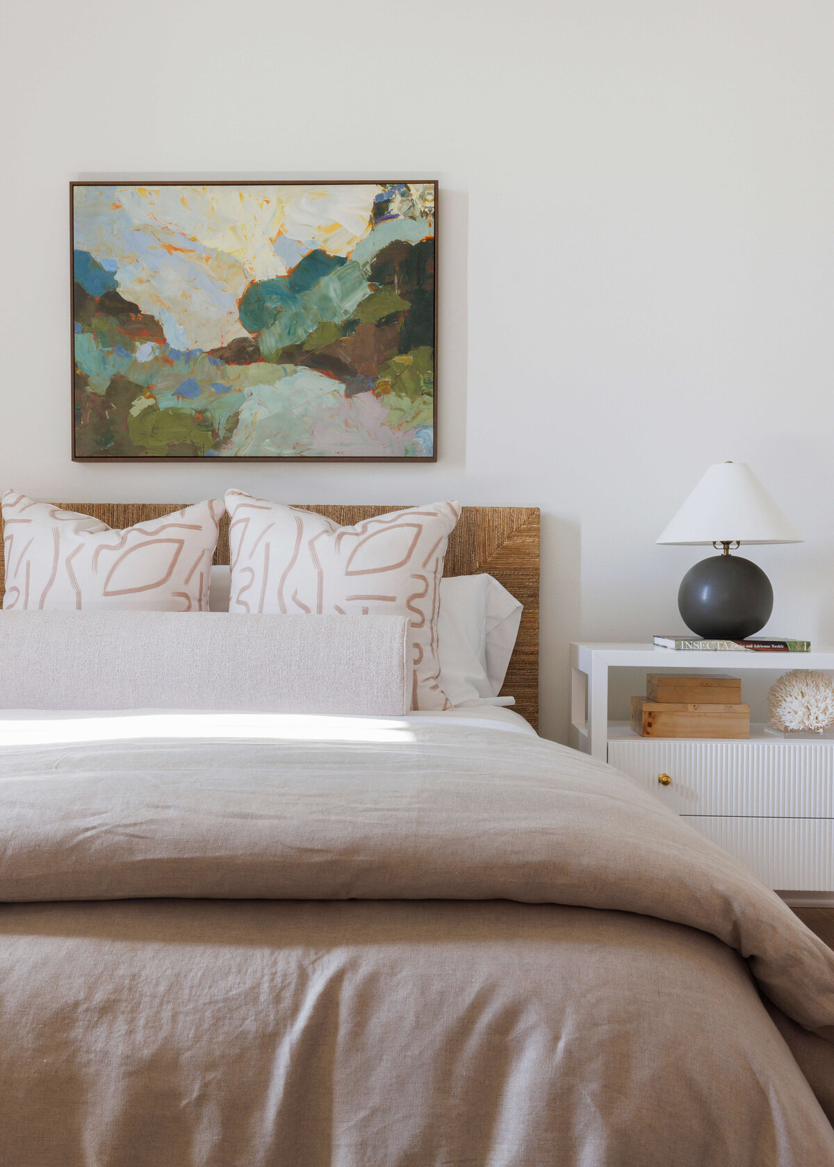 oyster creek studios hughes abstract landscape artwork and tan bedding in white bedroom