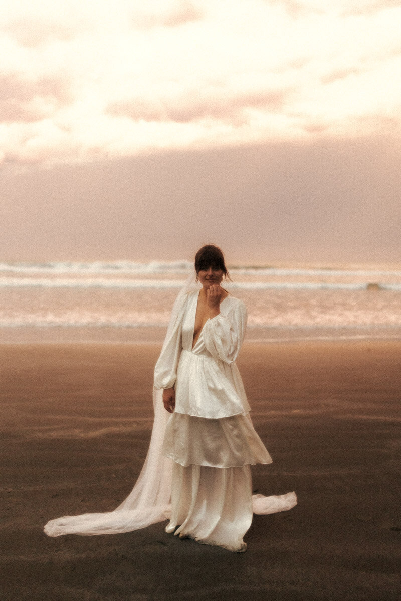 A wedding portrait taken of a bride at Ohope Beach with a vintage and film style look by Eilish Burt Photography