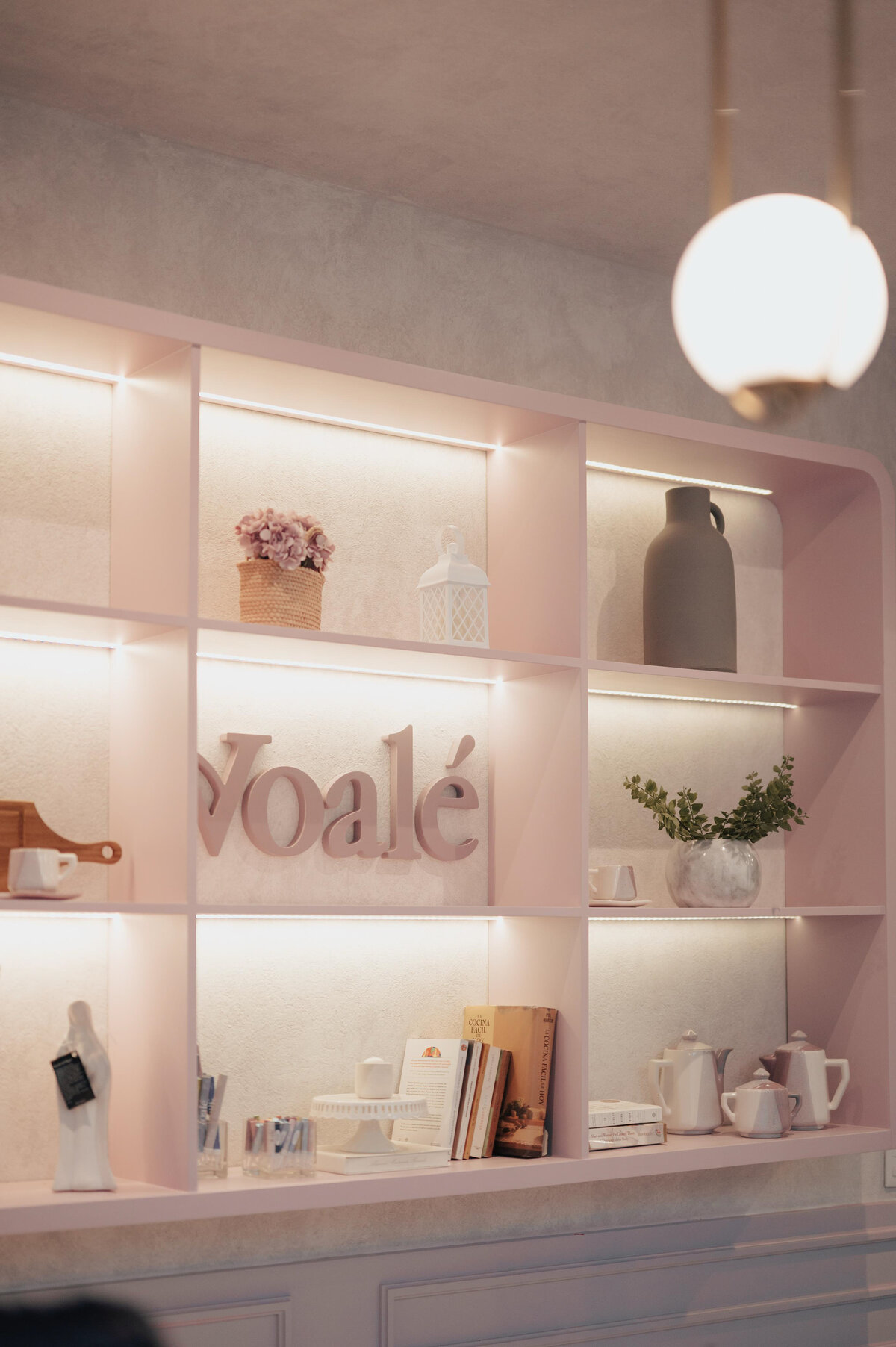 Interior design space showcasing the branding for Voalé, featuring elegant shelving, minimalist packaging elements, and timeless french styling.