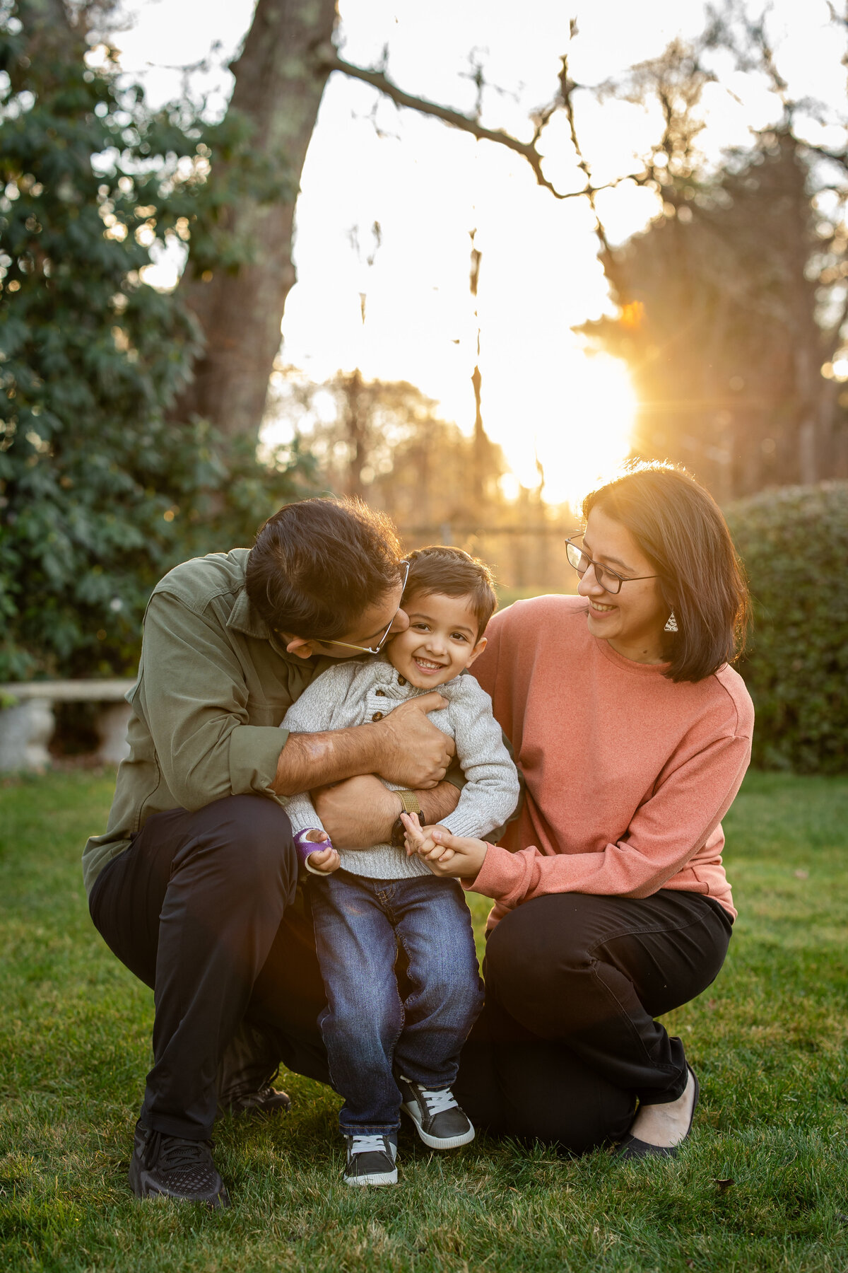 Parents hugging son during extended family session