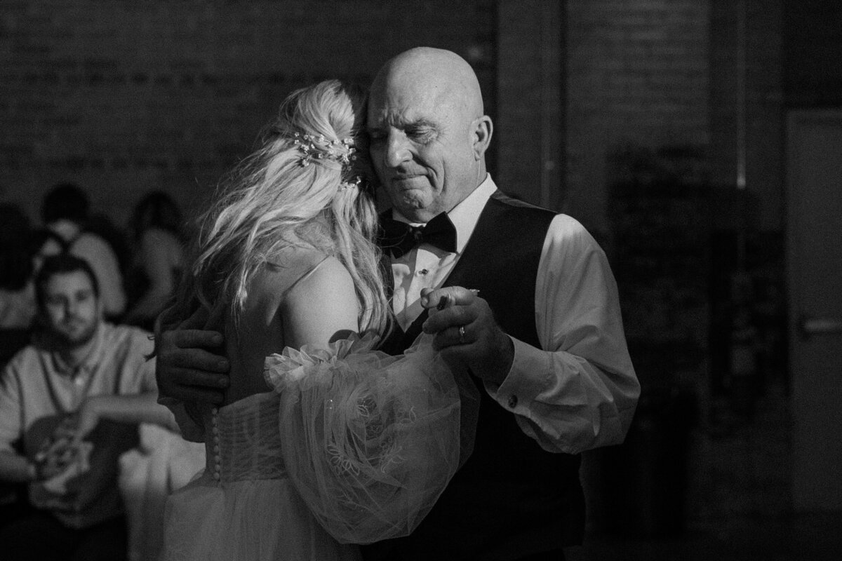 A older person dancing with a newlywed.